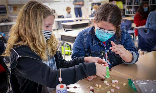 students work to build a bridge